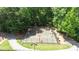 A fenced community basketball court surrounded by a canopy of mature trees at 3902 Butterstream Way, Kennesaw, GA 30144