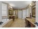 Spacious bathroom featuring a soaking tub, glass shower, and dual vanities at 3902 Butterstream Way, Kennesaw, GA 30144