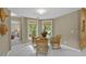 Cozy dining area featuring bamboo furniture, neutral walls, and ample natural light at 3902 Butterstream Way, Kennesaw, GA 30144
