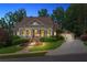 Charming home exterior with inviting porch, manicured landscaping, and spacious driveway at 3902 Butterstream Way, Kennesaw, GA 30144