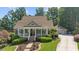 Charming home with a welcoming front porch, manicured landscaping, and a long driveway leading to a two-car garage at 3902 Butterstream Way, Kennesaw, GA 30144