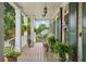 Charming front porch with potted plants and hanging lanterns, offering a cozy and inviting outdoor space at 3902 Butterstream Way, Kennesaw, GA 30144