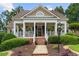 Inviting front porch adorned with hanging plants and a beautiful doorway, offering a warm welcome at 3902 Butterstream Way, Kennesaw, GA 30144