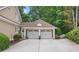 Spacious two-car garage featuring white doors and stylish architecture, with a convenient side entrance at 3902 Butterstream Way, Kennesaw, GA 30144