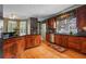 Traditional-style kitchen featuring wooden cabinets, granite countertops, and hardwood floors at 3902 Butterstream Way, Kennesaw, GA 30144