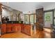 Open concept kitchen with stone accent wall, wooden cabinets and hardwood floors at 3902 Butterstream Way, Kennesaw, GA 30144
