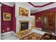 Cozy living room with stone fireplace, white mantle, and eye-catching horse artwork at 3902 Butterstream Way, Kennesaw, GA 30144