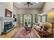 Cozy living room with a fireplace, large windows, and comfortable seating for relaxing or entertaining guests at 3902 Butterstream Way, Kennesaw, GA 30144