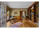 Elegant office space featuring custom built-in bookshelves and a charming view of the outdoors at 3902 Butterstream Way, Kennesaw, GA 30144