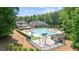 A luxurious community pool and splash pad are surrounded by mature trees at 3902 Butterstream Way, Kennesaw, GA 30144