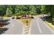 A landscaped roundabout at the entrance to the community shows manicured greenery at 3902 Butterstream Way, Kennesaw, GA 30144