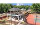 Multiple well-maintained tennis courts with covered viewing area for spectators at 3902 Butterstream Way, Kennesaw, GA 30144