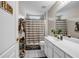 Hall bathroom with shower/tub combo, white vanity, and tiled floors is functional and bright at 803 Baugh Springs Ln, Lawrenceville, GA 30044