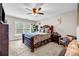 Cozy bedroom with a ceiling fan, carpet floors, and natural light offers a peaceful space at 803 Baugh Springs Ln, Lawrenceville, GA 30044