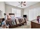 Comfortable bedroom with a ceiling fan, double-door closet, and a window for natural light at 803 Baugh Springs Ln, Lawrenceville, GA 30044
