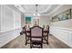 Formal dining room features decorative molding, a modern chandelier, and large windows at 803 Baugh Springs Ln, Lawrenceville, GA 30044