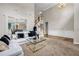 Open concept living room features tall ceilings, large windows, fireplace and staircase at 803 Baugh Springs Ln, Lawrenceville, GA 30044