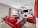 Inviting living room with a cozy fireplace, built-in shelves, and stylish red leather furniture at 803 Baugh Springs Ln, Lawrenceville, GA 30044