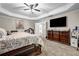 Large primary bedroom features a tray ceiling, ceiling fan, and plenty of space for relaxation at 803 Baugh Springs Ln, Lawrenceville, GA 30044