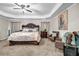 Spacious main bedroom features a ceiling fan, carpet floors, a sitting area, and natural light at 803 Baugh Springs Ln, Lawrenceville, GA 30044