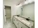 Modern bathroom with double vanity, granite countertops, white cabinets, and marble flooring at 1540 Ox Bridge Ct, Lawrenceville, GA 30043