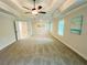 Large primary bedroom features a tray ceiling, ample natural light, and an en-suite bathroom at 1540 Ox Bridge Ct, Lawrenceville, GA 30043