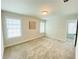 Bright bedroom with neutral walls, plush carpet, and natural light from two windows at 1540 Ox Bridge Ct, Lawrenceville, GA 30043