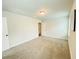 Neutral bedroom featuring plush carpet, light walls, a simple light fixture and two doors at 1540 Ox Bridge Ct, Lawrenceville, GA 30043