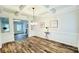 Dining room featuring a coffered ceiling, wainscotting, and hardwood floors at 1540 Ox Bridge Ct, Lawrenceville, GA 30043
