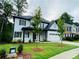 Inviting two-story home with a manicured front yard and classic black-and-white design at 1540 Ox Bridge Ct, Lawrenceville, GA 30043