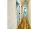 Bright hallway featuring hardwood floors and a white door frame at 1540 Ox Bridge Ct, Lawrenceville, GA 30043