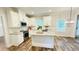 Bright kitchen features an island, stainless appliances, and granite countertops at 1540 Ox Bridge Ct, Lawrenceville, GA 30043