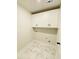 Bright laundry room with white cabinets and marbled tile flooring at 1540 Ox Bridge Ct, Lawrenceville, GA 30043