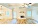 Bright living room with coffered ceiling, fireplace, and wood-look flooring at 1540 Ox Bridge Ct, Lawrenceville, GA 30043