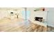 Living room featuring fireplace, wood-look flooring, and view into the kitchen at 1540 Ox Bridge Ct, Lawrenceville, GA 30043