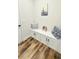 Mudroom featuring built in seating, storage cabinets and wood-look flooring at 1540 Ox Bridge Ct, Lawrenceville, GA 30043