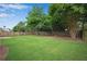 Beautiful backyard with lush green grass, mature shade trees and a wooden perimeter fence at 1712 Bonnabel Ne Trce, Marietta, GA 30066