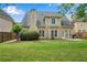 Wide backyard view of a home with a lush, green lawn, patio area, and mature landscaping at 1712 Bonnabel Ne Trce, Marietta, GA 30066