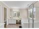 Bright bathroom featuring a tub, glass shower, double vanity and tile floors at 1712 Bonnabel Ne Trce, Marietta, GA 30066