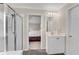 Clean bathroom showcasing a glass shower, vanity, and an open doorway to the bedroom at 1712 Bonnabel Ne Trce, Marietta, GA 30066