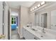 Well-lit bathroom with double vanity and a view of the bedroom from doorway at 1712 Bonnabel Ne Trce, Marietta, GA 30066