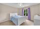Cozy bedroom with a white bed frame, neutral walls and a window with purple curtains at 1712 Bonnabel Ne Trce, Marietta, GA 30066