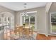 Bright dining room features wood floors, a chandelier, and a table with seating for four at 1712 Bonnabel Ne Trce, Marietta, GA 30066