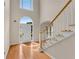 Sunlit entryway with high ceilings, wood floors, and a staircase at 1712 Bonnabel Ne Trce, Marietta, GA 30066