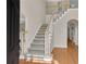 Inviting foyer featuring hardwood floors and a staircase with white railings at 1712 Bonnabel Ne Trce, Marietta, GA 30066