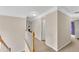 Upstairs hallway with neutral colors, carpet, and railing to downstairs at 1712 Bonnabel Ne Trce, Marietta, GA 30066