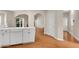 Open kitchen featuring white cabinets, stainless steel appliances and hardwood flooring at 1712 Bonnabel Ne Trce, Marietta, GA 30066