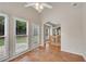 Sun room with tile floors, ceiling fan, and open archway to dining room at 1712 Bonnabel Ne Trce, Marietta, GA 30066