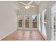 Bright sun room with tile floors, multiple windows, and a vaulted ceiling with ceiling fan at 1712 Bonnabel Ne Trce, Marietta, GA 30066