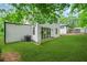 The backyard has an AC unit and sliding glass doors, with fresh green grass and a partial view of a neighboring house at 2926 5Th Sw St, Atlanta, GA 30315
